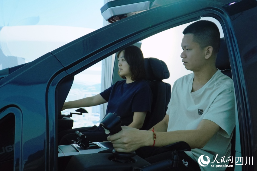 記者在AE200型“飛行汽車”模擬艙內(nèi)進(jìn)行體驗(yàn)。人民網(wǎng) 趙祖樂攝